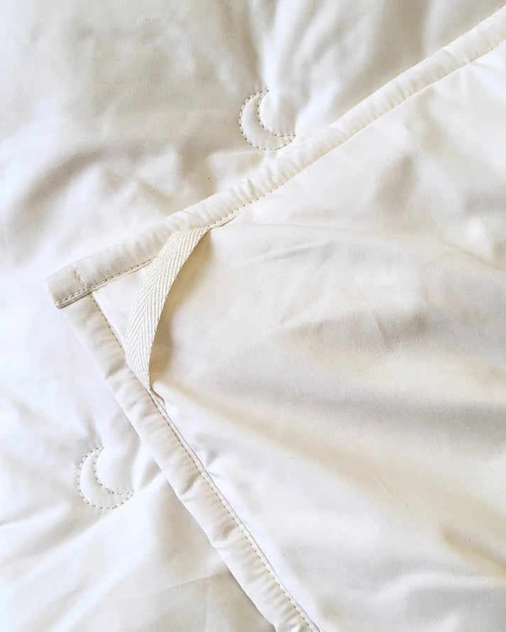 Cream-colored alpaca and wool comforter by Crescent Moon, soft and cozy with textured fabric and plush filling.