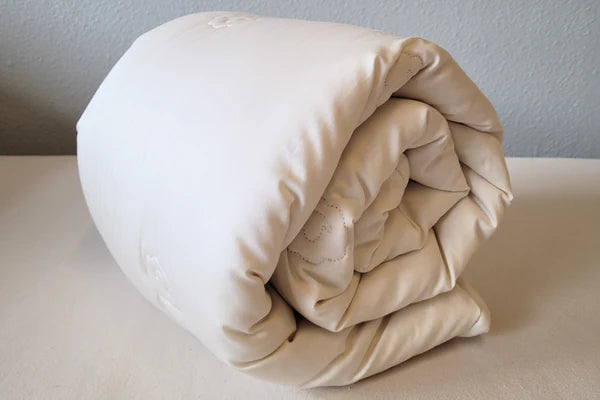 Organic toddler wool comforter for babies, from Holy Lamb Organics, soft and cozy with natural wool fibers visible.