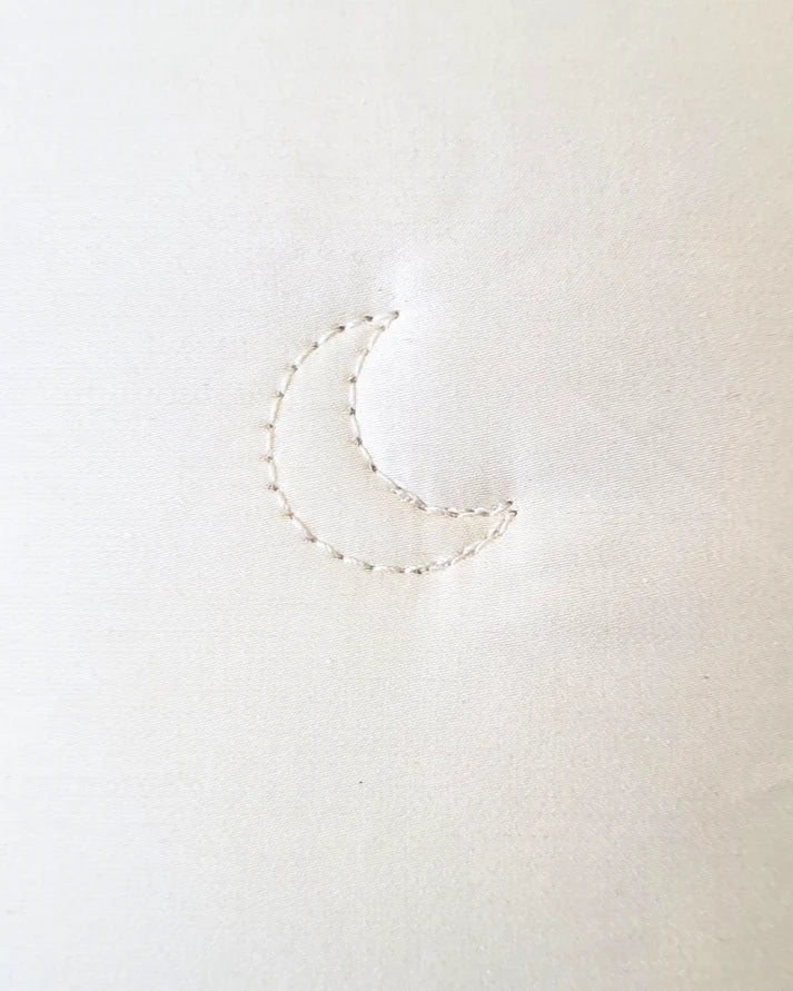 Crescent Moon alpaca and wool comforter spread out on a bed, showcasing its soft, cozy fabric and plush texture.