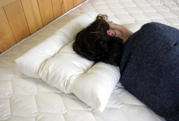 Orthopedic neck pillow by Holy Lamb Organics with supportive contour design for comfortable sleep and neck relief.