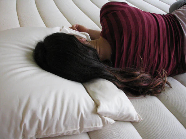 Holy Lamb Organics neck roll pillow with soft, supportive fabric and cylindrical shape for neck and shoulder comfort.