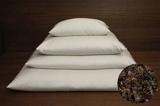 Round buckwheat hull pillow from Soaring Heart, soft filling visible with a smooth cover in a circular shape.