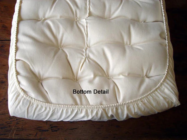 Baby bassinet fitted sheet by Holy Lamb Organics, soft and fitted for a cozy sleeping area, with white and pastel fabric details.