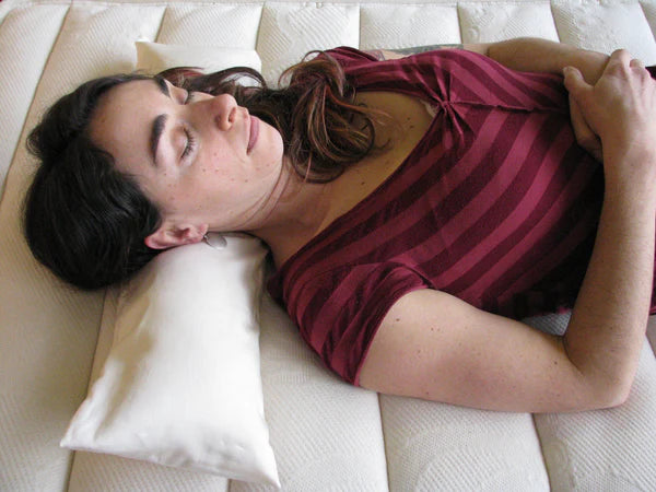 Holy Lamb Organics neck roll pillow with soft fabric cover, designed for neck support and comfort.