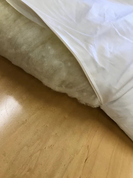 Holy Lamb Organics wool and latex mattress topper showing plush, natural fiber surface and quilted design for added comfort.