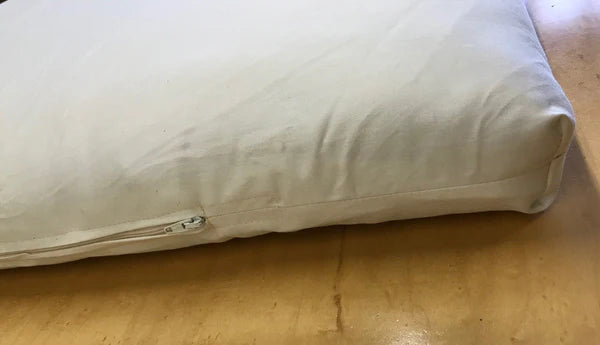 Holy Lamb Organics wool and latex mattress topper showcasing a plush, eco-friendly bedding accessory on a bed.