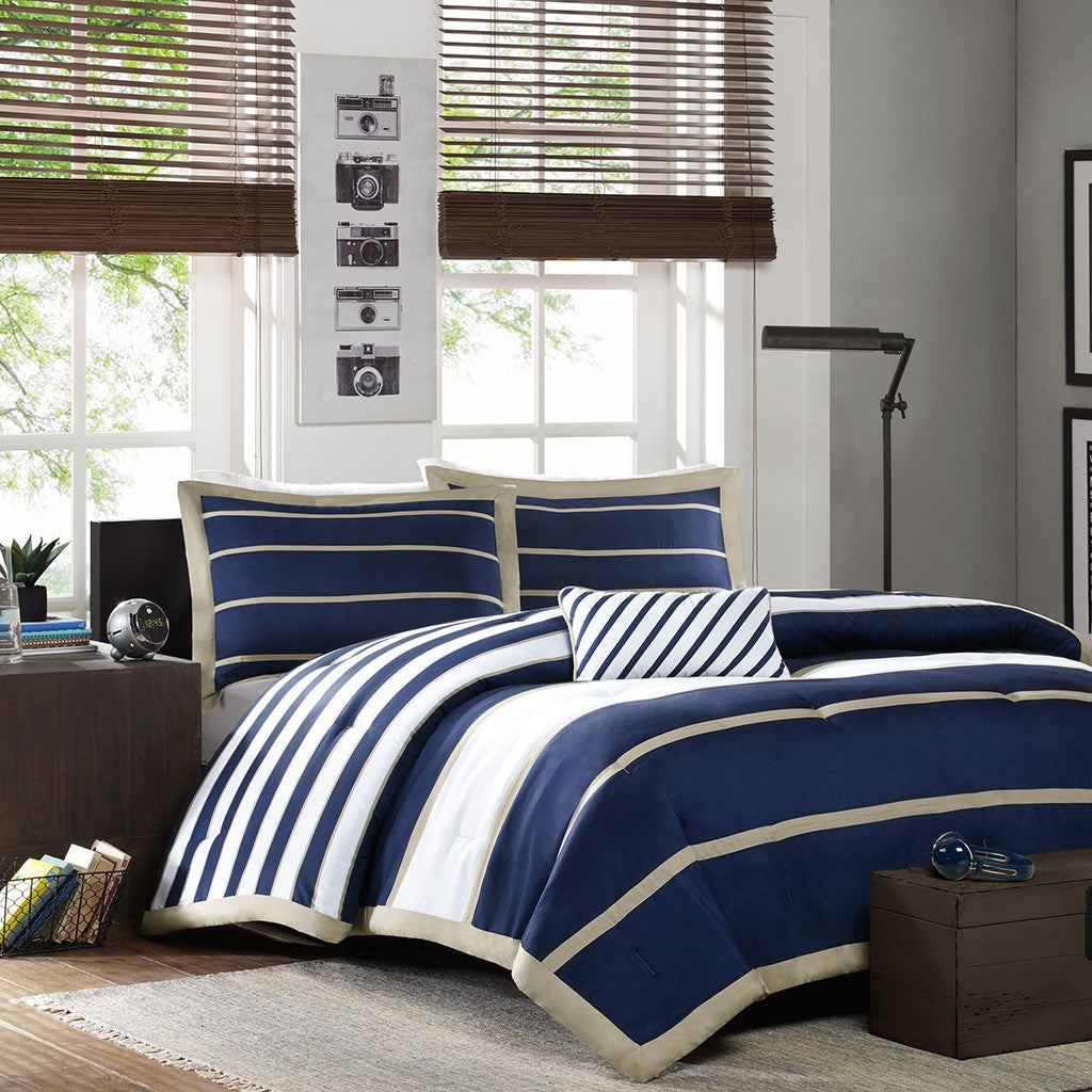 Navy and white striped bedding set in a bedroom with large windows.