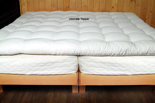 Natural quilted wool mattress topper by Holy Lamb Organics, showcasing plush, textured fabric for added comfort and support.