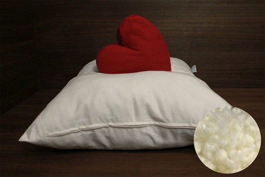Organic wool bolus pillow from Soaring Heart showing a close-up of the soft, filling circle with natural wool fibers.