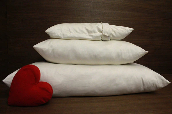 Organic wool bolus pillow by Soaring Heart, showcasing the soft, natural wool filling and cozy pillow cover.