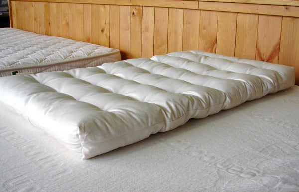 Natural wool baby bassinet mattress by Holy Lamb Organics, showcasing a soft, plush surface suitable for a peaceful sleep.