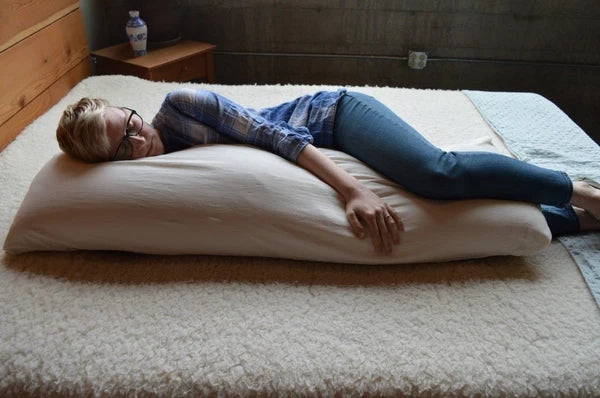 Large natural body pillow from Holy Lamb Organics with soft, organic fabric, ideal for comfortable sleep and full-body support.