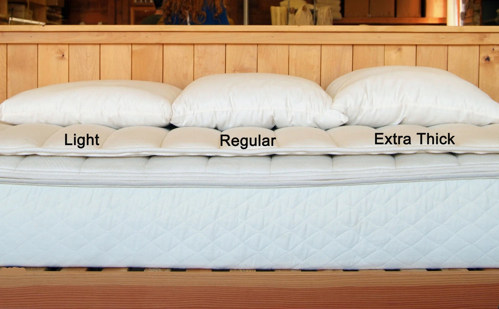 All-natural wool-filled bed pillows by Holy Lamb Organics with varying thicknesses for plush, comfortable sleep support.