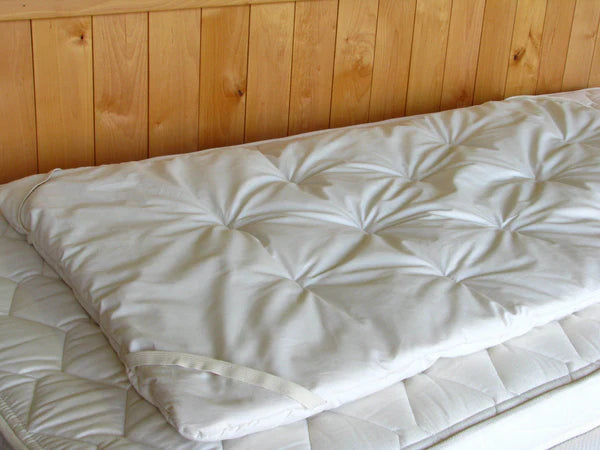 Organic baby crib mattress topper from Holy Lamb Organics, soft and cushioned for a comfortable baby sleep surface.