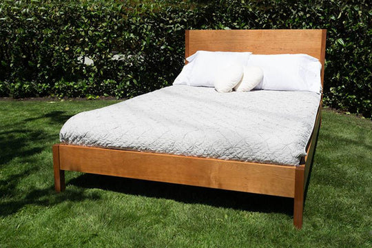 Organic latex mattress by Soaring Heart, showing the natural latex surface and plush fabric cover in a cozy bedroom setting.