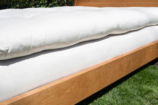 Royal Organic Latex and Wool Mattress Topper by Soaring Heart, showing a plush, eco-friendly topper on a bed with natural linens.
