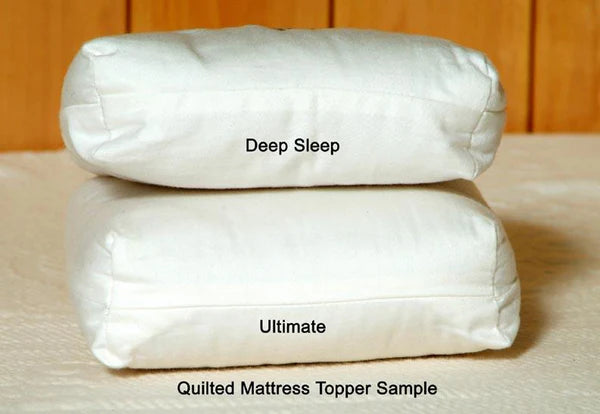 Natural quilted mattress topper by Holy Lamb Organics with plush, textured surface for added comfort and support.