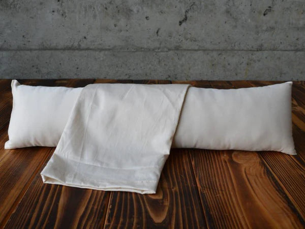 Holy Lamb Organics neck roll pillow with matching cover, designed for neck support and comfort.