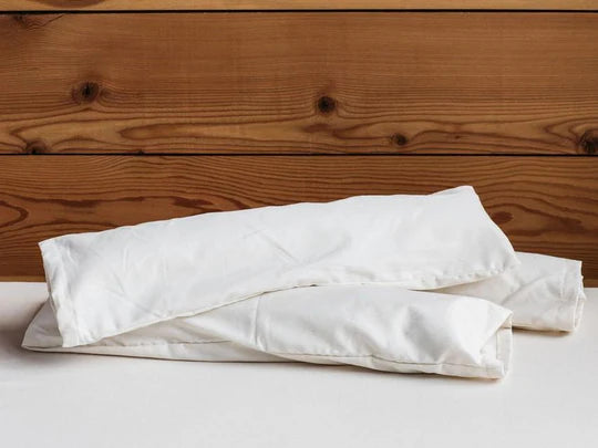 Holy Lamb Organics neck roll pillow with soft, supportive fabric suitable for neck and shoulder comfort.