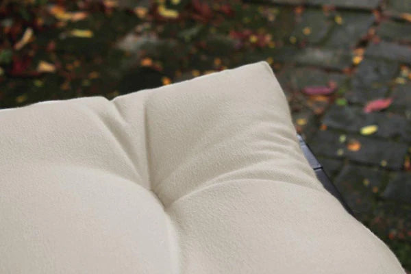 Organic cotton, latex, and wool futon mattress by Soaring Heart, showing a neatly folded natural-fiber futon on a wooden floor.