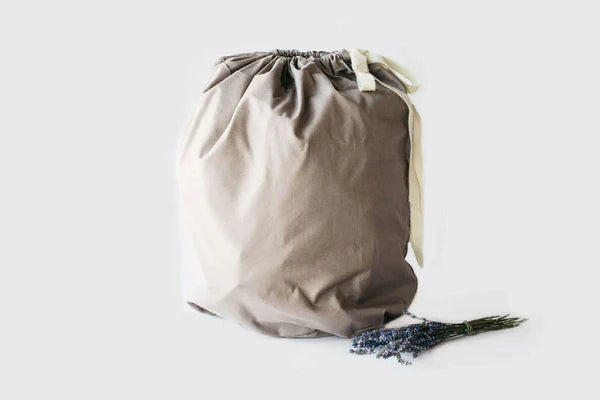 All-natural wool sleeping bag by Holy Lamb Organics, cozy and insulated, shown rolled up with soft wool fabric visible.