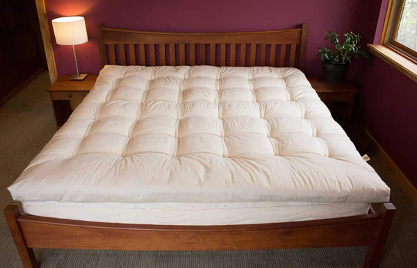 Organic quilted mattress topper by Holy Lamb Organics, plush, padded bedding accessory for added comfort on a bed.
