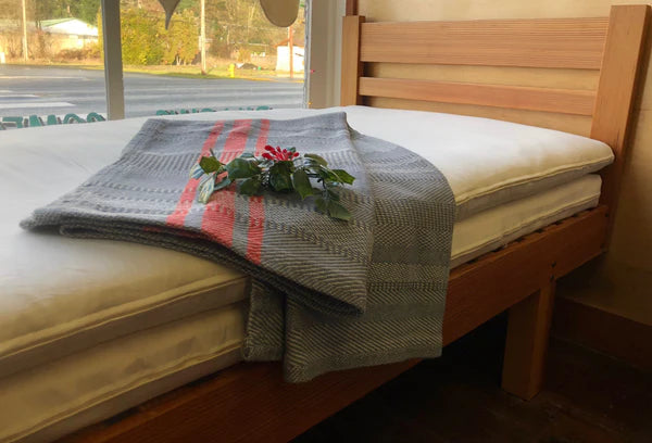 Holy Lamb Organics wool and latex mattress topper on bed, showcasing plush, natural bedding for added comfort.
