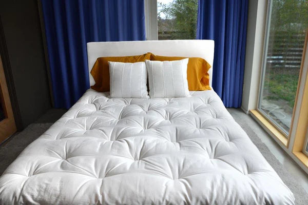 Soaring Heart deluxe organic wool mattress topper showing soft, plush wool surface with quilted stitching for added comfort.