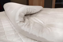 Organic latex mattress topper from Soaring Heart, showing the plush, eco-friendly topper with a smooth surface and natural texture.