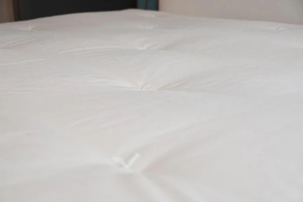 Organic latex mattress topper from Soaring Heart, showing a plush, eco-friendly layer designed for comfort and support.