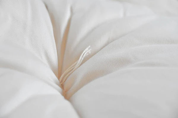 Organic wool mattress topper by Soaring Heart, soft and plush layer for added comfort and natural support on a bed.