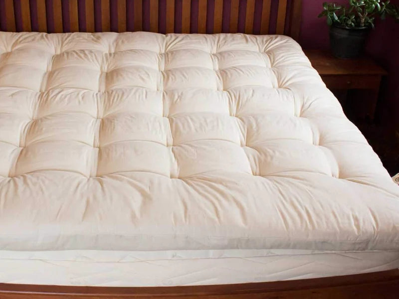All-natural quilted mattress topper from Holy Lamb Organics featuring soft, plush fabric and a cozy, padded design for added comfort.